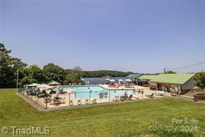 view of swimming pool with a lawn