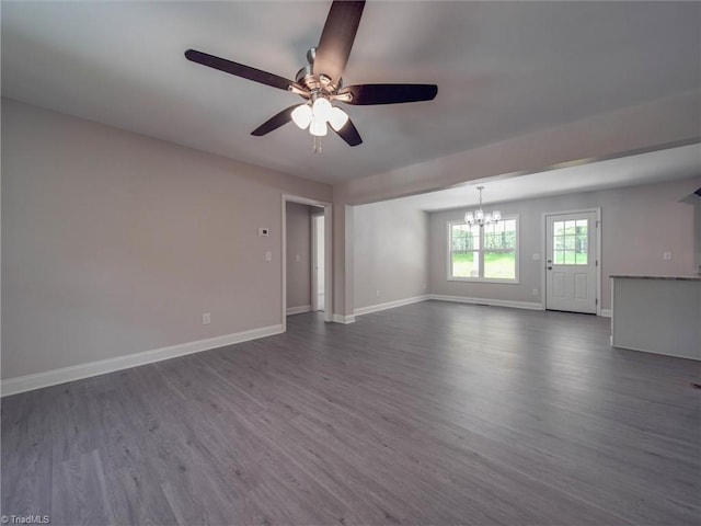 unfurnished room featuring ceiling fan with notable chandelier and dark hardwood / wood-style flooring