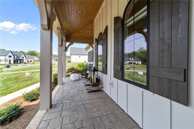 7604 Pemberley Dr, Oak Ridge, NC 27310 - covered porch featuring a residential view and a lawn