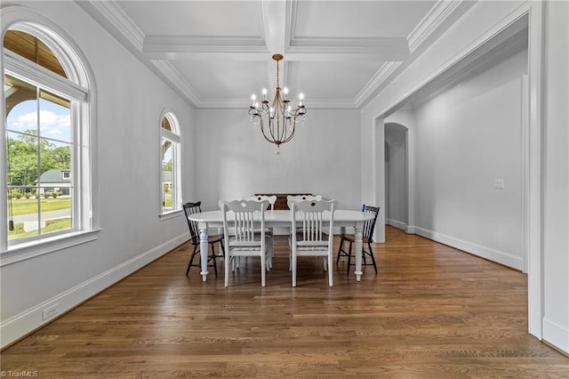 7604 Pemberley Dr, Oak Ridge, NC 27310 - dining room featuring coffered ceiling, a chandelier, arched walkways, wood finished floors, and ornamental molding