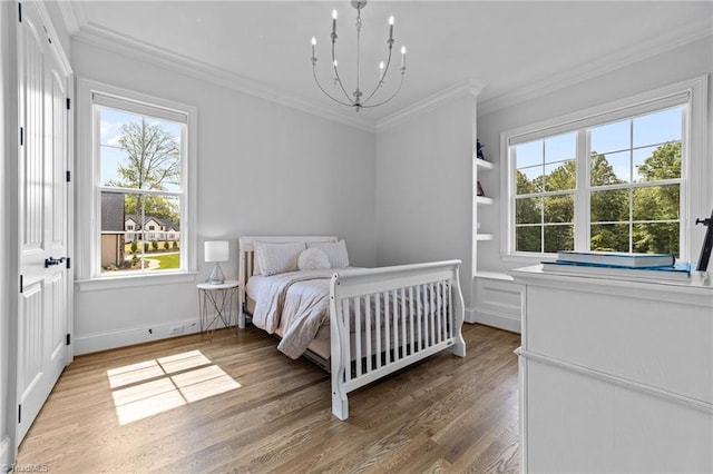 7604 Pemberley Dr, Oak Ridge, NC 27310 - bedroom with wood finished floors, a chandelier, and ornamental molding