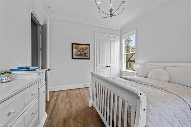 7604 Pemberley Dr, Oak Ridge, NC 27310 - bedroom featuring a chandelier, wood finished floors, crown molding, and a closet