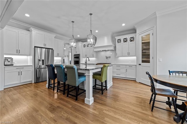 7604 Pemberley Dr, Oak Ridge, NC 27310 - kitchen with wall chimney range hood, stainless steel appliances, ornamental molding, a kitchen bar, and recessed lighting
