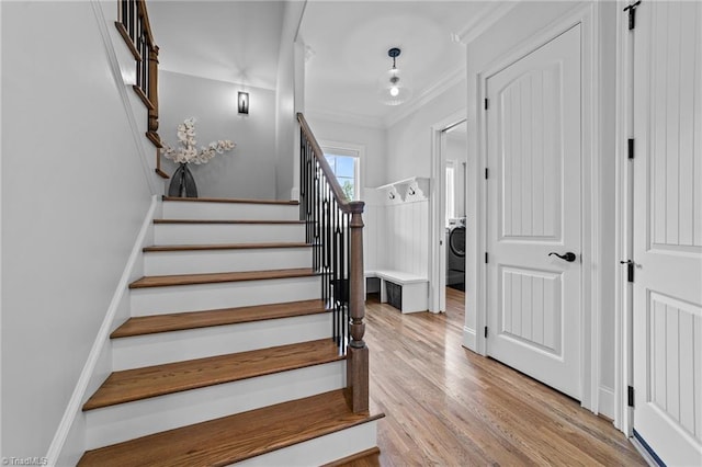 7604 Pemberley Dr, Oak Ridge, NC 27310 - staircase with ornamental molding, wood finished floors, and washer / clothes dryer