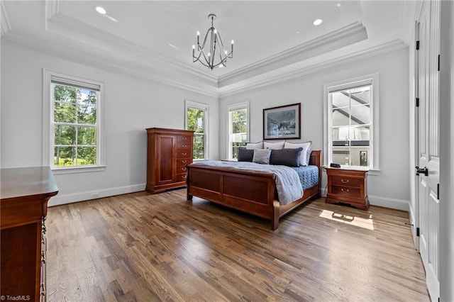 7604 Pemberley Dr, Oak Ridge, NC 27310 - bedroom featuring a raised ceiling, crown molding, wood finished floors, a chandelier, and recessed lighting