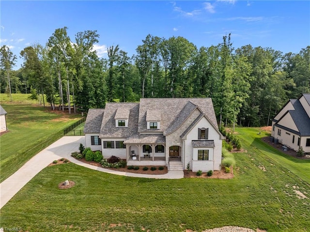 7604 Pemberley Dr, Oak Ridge, NC 27310 - view of front of property with covered porch, a front yard, and driveway