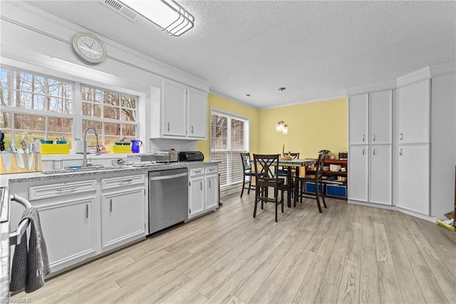 kitchen with dishwasher, light wood-style flooring, white cabinets, and a sink