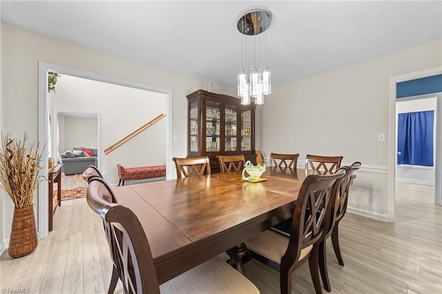 dining room featuring light wood-style floors and an inviting chandelier