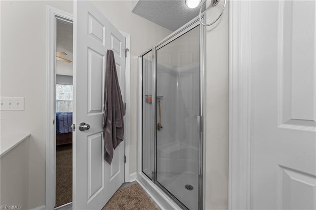 full bath with ensuite bath, a stall shower, and a textured ceiling