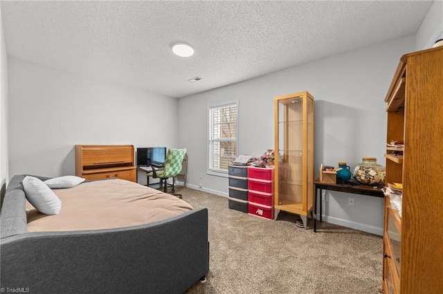 bedroom featuring visible vents, a textured ceiling, baseboards, and carpet floors