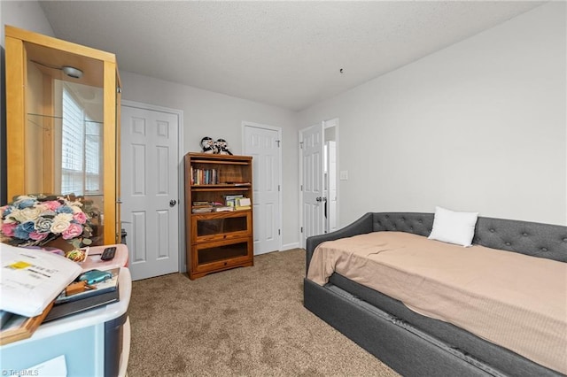 carpeted bedroom featuring a textured ceiling