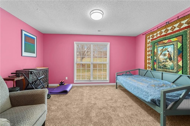 bedroom featuring visible vents, a textured ceiling, baseboards, and carpet floors