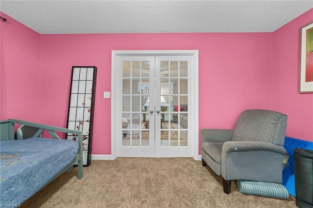 carpeted bedroom featuring french doors and a textured ceiling