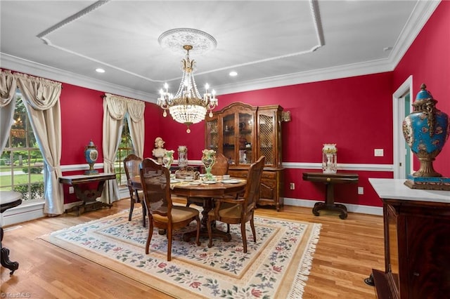 dining room featuring crown molding, hardwood / wood-style floors, and a chandelier