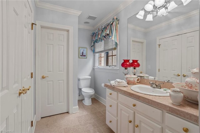 bathroom with an inviting chandelier, crown molding, vanity, and toilet