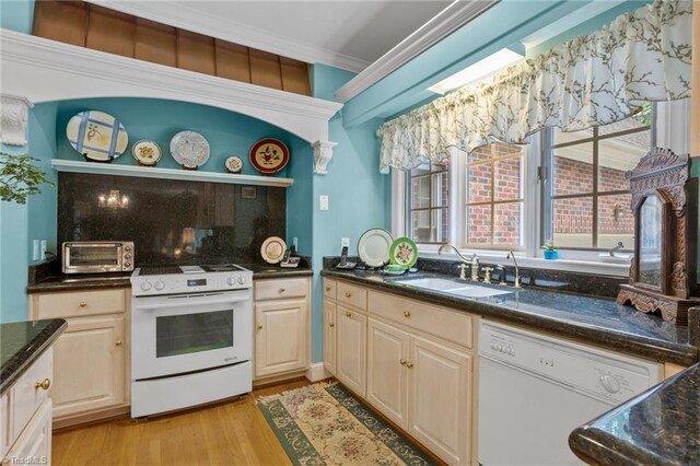 kitchen featuring decorative backsplash, white appliances, light wood-type flooring, ornamental molding, and sink