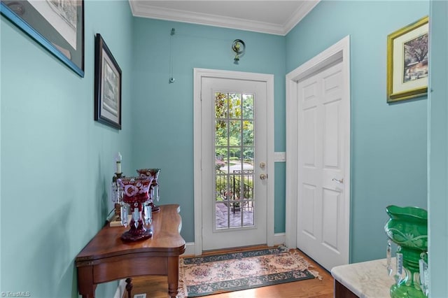 entryway featuring wood-type flooring and ornamental molding