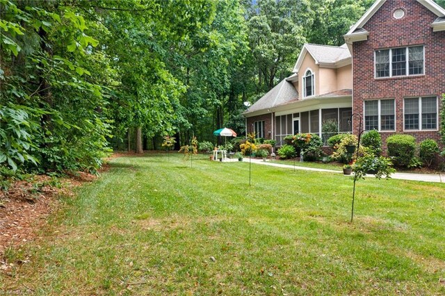 view of yard with a sunroom