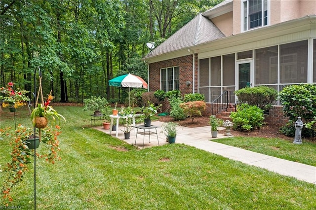 view of yard with a sunroom and a patio