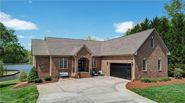 view of front of house with concrete driveway, a front yard, brick siding, and a garage