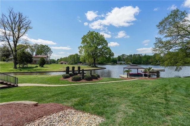 dock area featuring a water view, a gazebo, and a lawn