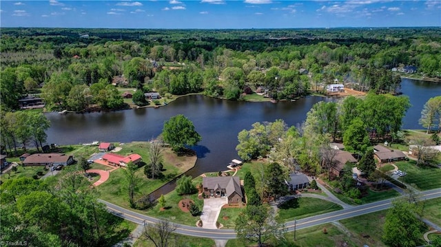 aerial view with a water view and a wooded view