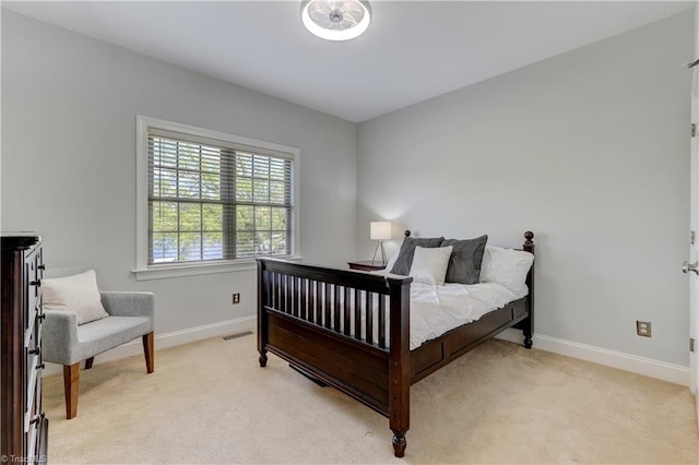 bedroom with visible vents, light colored carpet, and baseboards