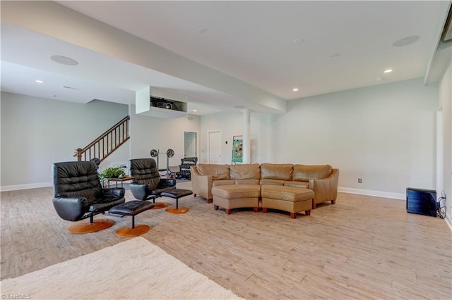 living room with light wood-style floors, recessed lighting, baseboards, and stairs