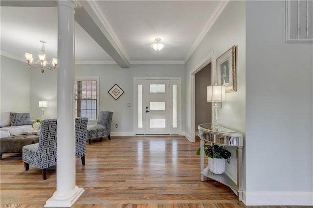 entryway with ornate columns, ornamental molding, visible vents, and light wood-type flooring