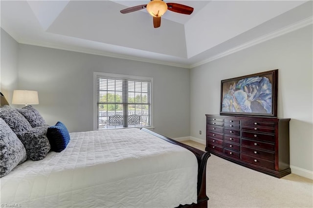 carpeted bedroom with a tray ceiling, baseboards, and a ceiling fan