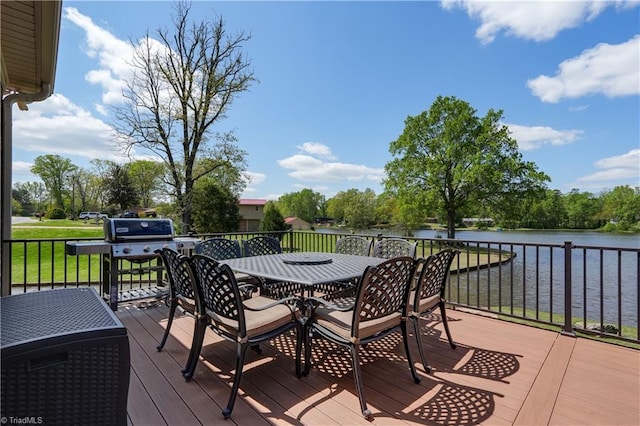 wooden deck with outdoor dining space, a grill, and a water view