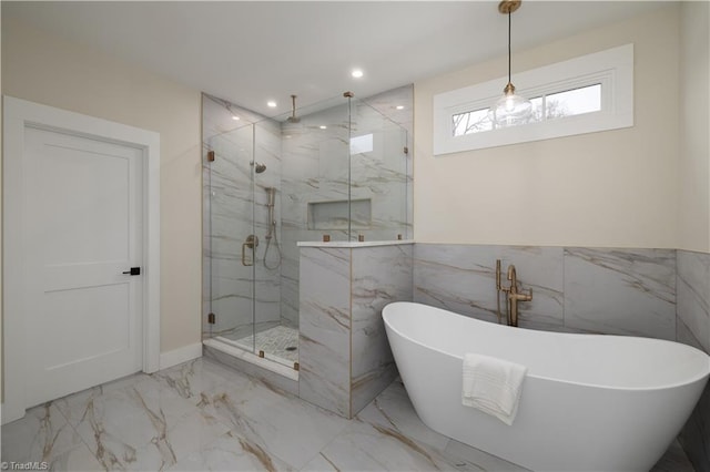 full bath featuring marble tiled flooring, a marble finish shower, a freestanding tub, recessed lighting, and tile walls