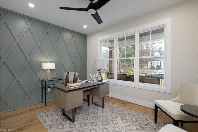 office with baseboards, a ceiling fan, recessed lighting, light wood-type flooring, and a decorative wall