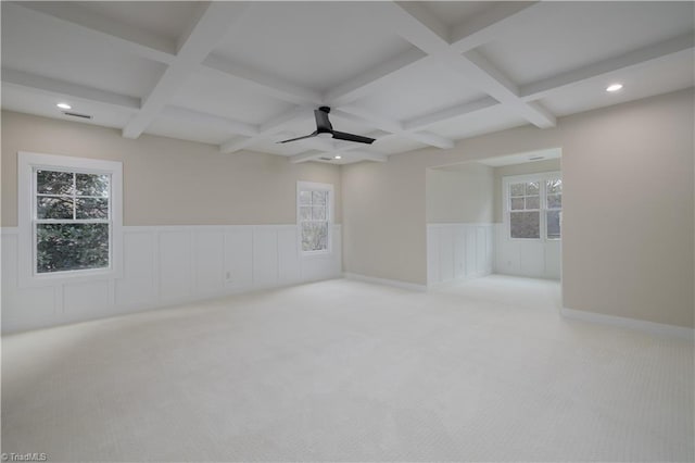 carpeted spare room with coffered ceiling, wainscoting, beamed ceiling, a ceiling fan, and recessed lighting