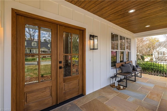 entrance to property featuring covered porch and french doors