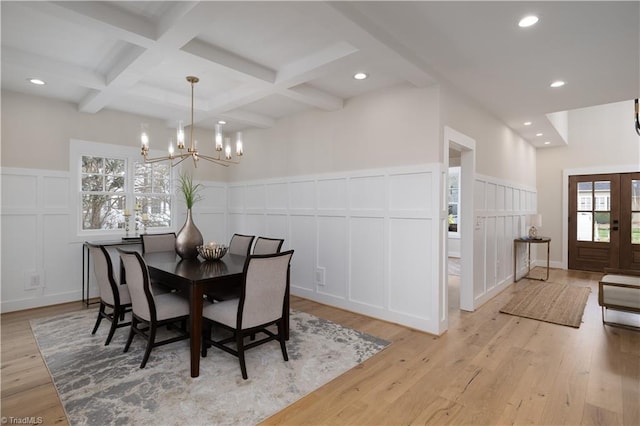 dining area featuring a decorative wall, a chandelier, beam ceiling, light wood finished floors, and recessed lighting