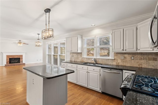 kitchen with white cabinetry, sink, pendant lighting, and appliances with stainless steel finishes