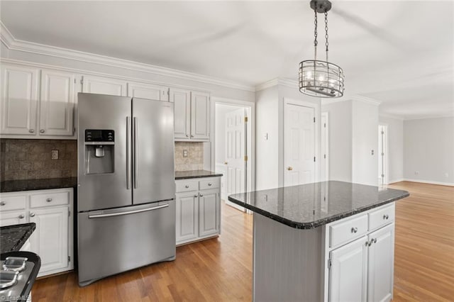 kitchen featuring a kitchen island, pendant lighting, white cabinetry, stainless steel fridge with ice dispenser, and light hardwood / wood-style flooring