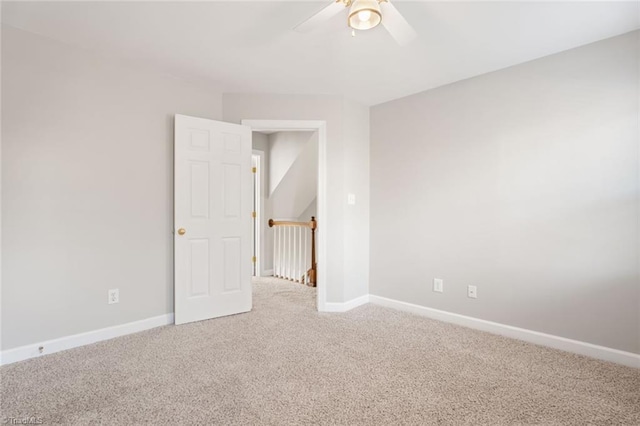 carpeted empty room featuring ceiling fan