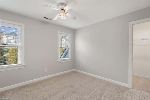 carpeted empty room with ceiling fan