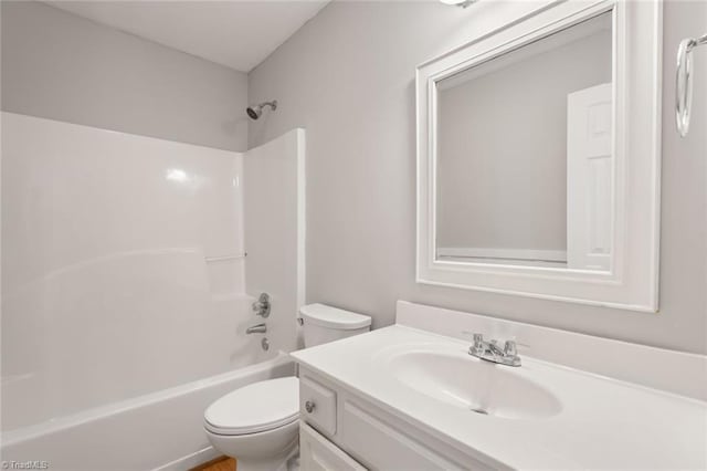 full bathroom featuring  shower combination, vanity, and toilet