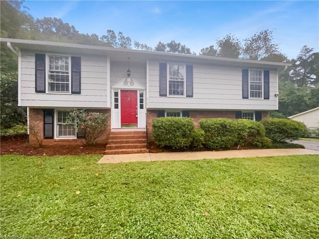 bi-level home with a front lawn