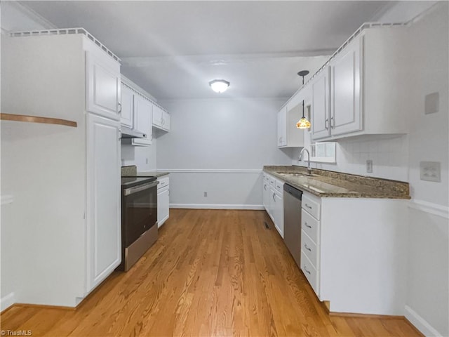 kitchen featuring light wood-type flooring, sink, white cabinetry, hanging light fixtures, and stainless steel appliances