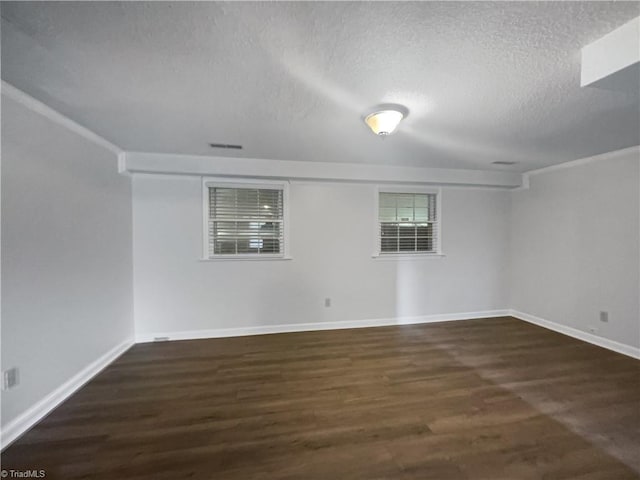 unfurnished room featuring a textured ceiling and dark wood-type flooring