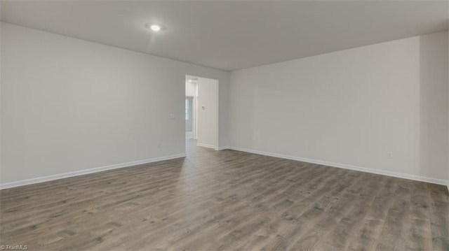 spare room with wood-type flooring