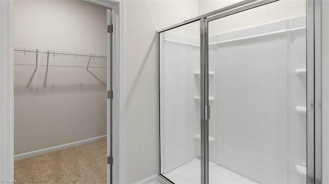 bathroom with a shower with door