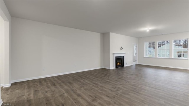 unfurnished living room with dark wood-type flooring