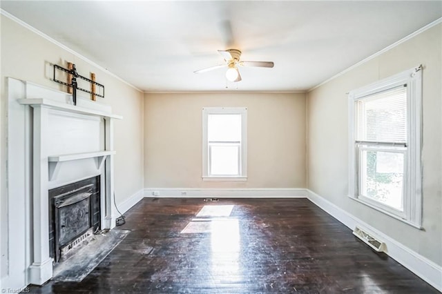 unfurnished living room with a healthy amount of sunlight, visible vents, a fireplace with flush hearth, ceiling fan, and crown molding