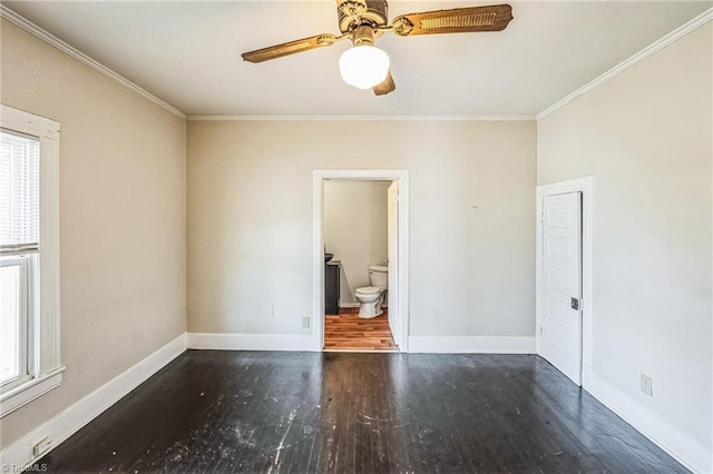 empty room with a wealth of natural light, wood finished floors, ceiling fan, and crown molding