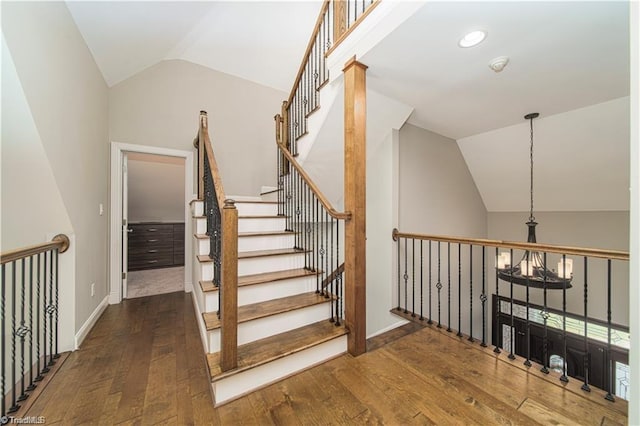 staircase featuring vaulted ceiling, hardwood / wood-style flooring, baseboards, and recessed lighting